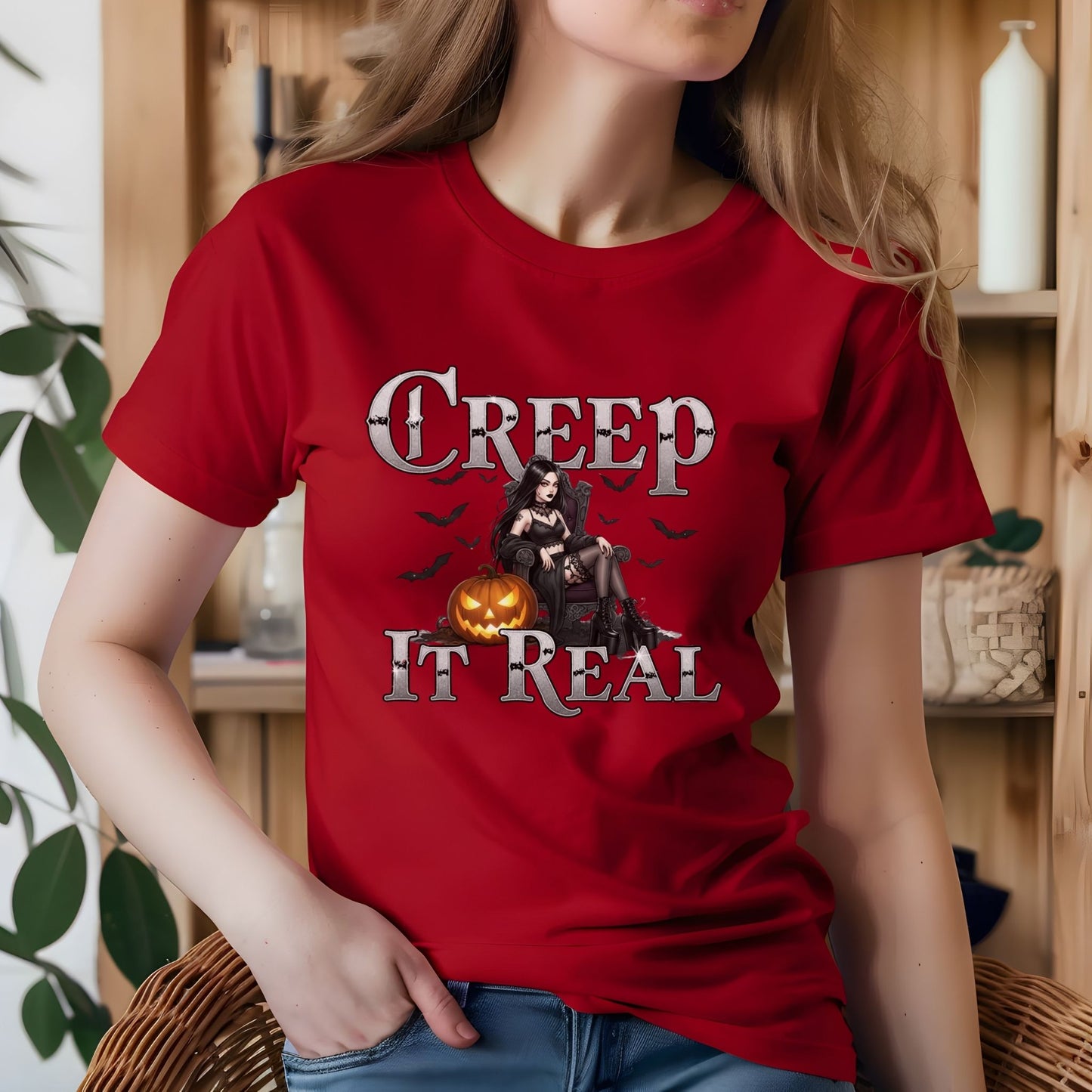 Person wearing a red t-shirt with Halloween-themed design and text.