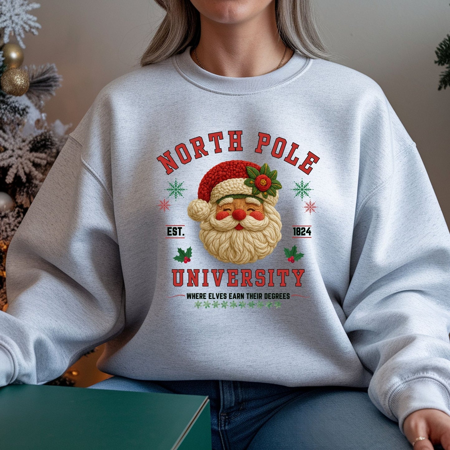 Person wearing a light gray sweatshirt with a Christmas-themed design featuring Santa Claus and text.