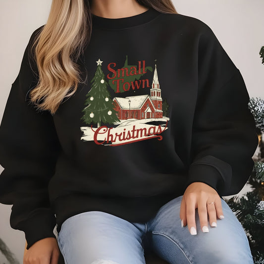 Person wearing a black sweatshirt with 'Small Town Christmas' design