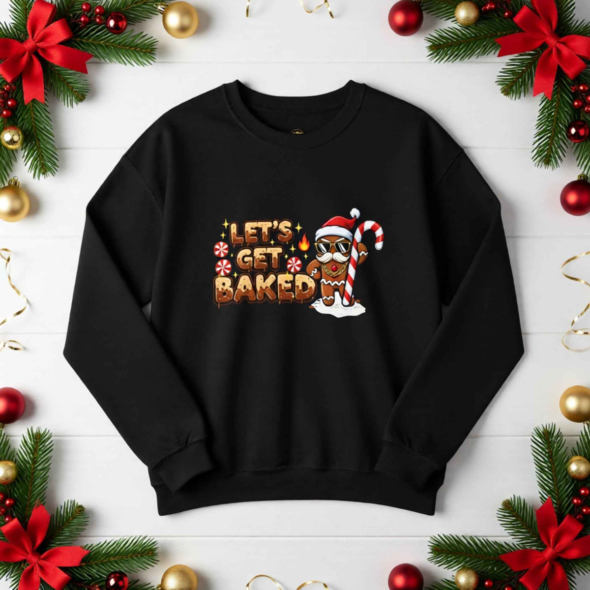 Flat lay of ‘Let’s Get Baked’ gingerbread Christmas crewneck sweatshirt with festive holiday background
