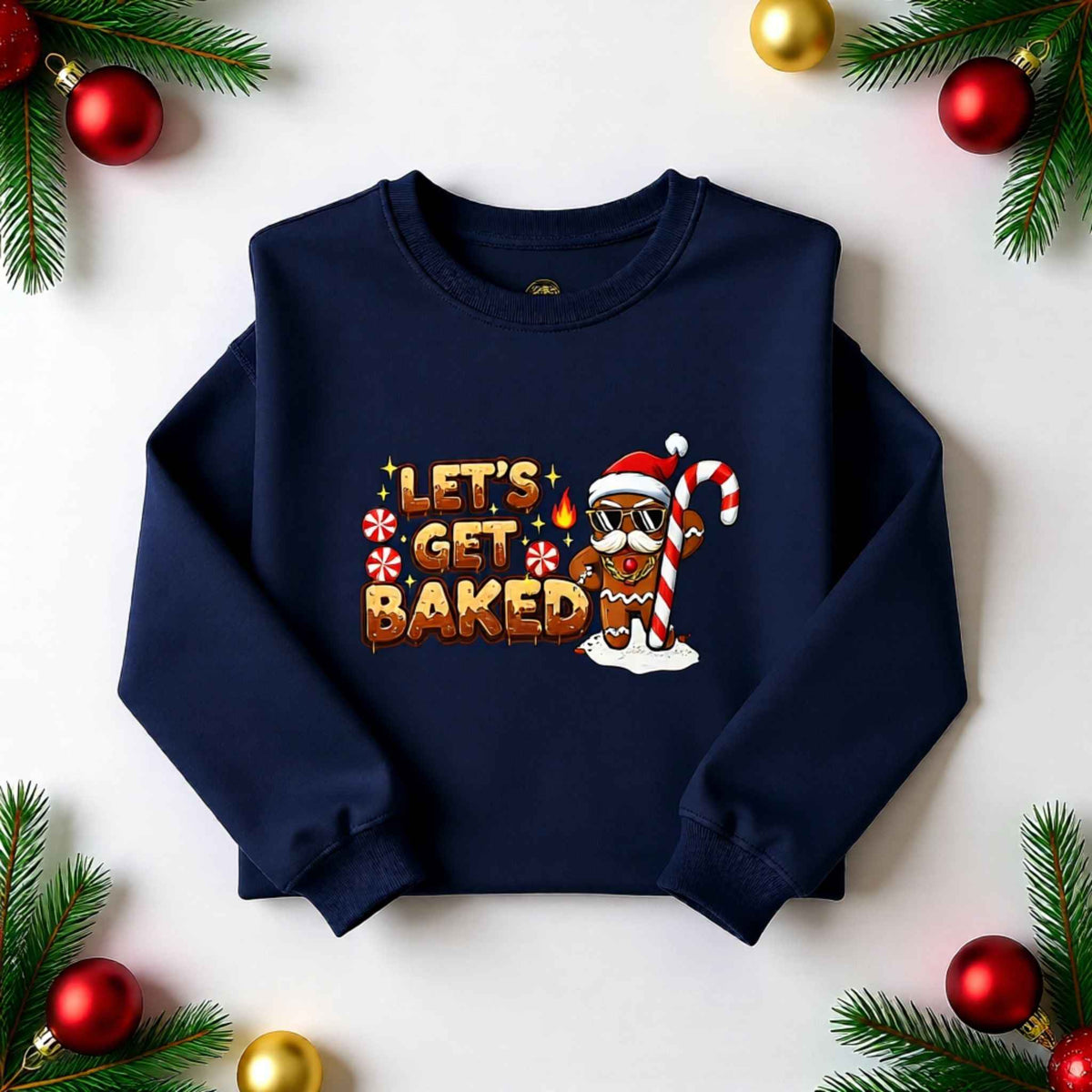 Flat lay of ‘Let’s Get Baked’ gingerbread Christmas crewneck sweatshirt with festive holiday background