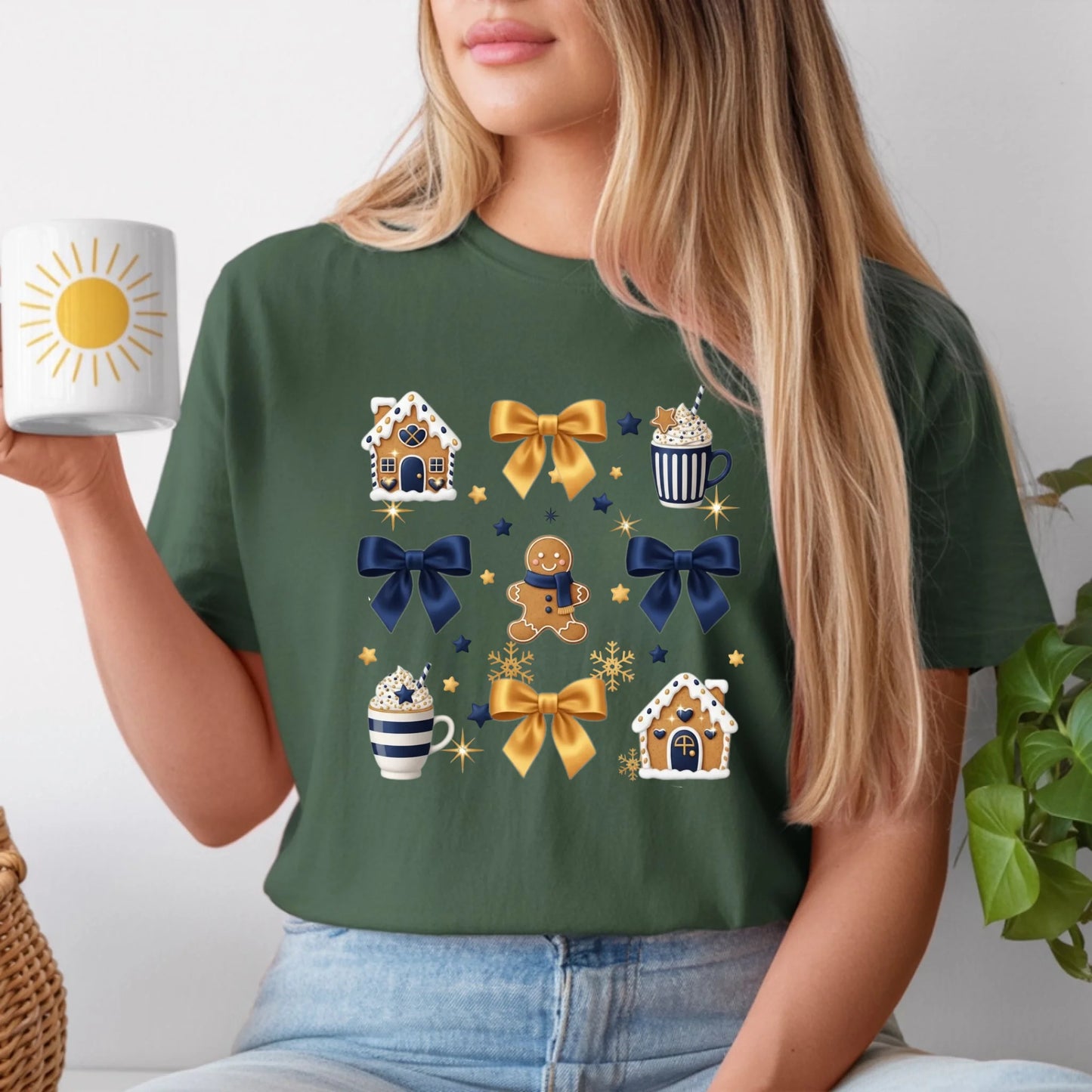 Person wearing a green t-shirt with festive designs, holding a mug.