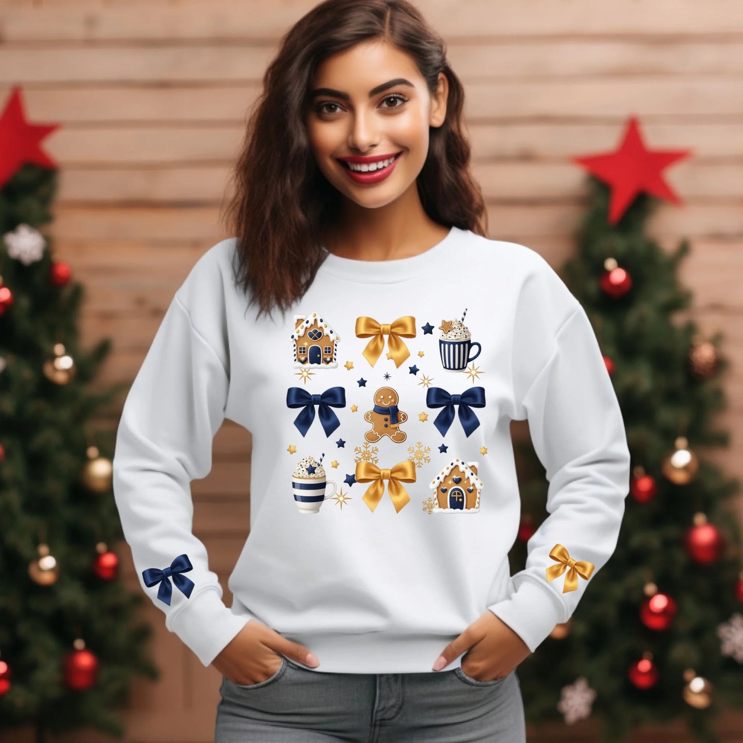 Woman wearing a white sweatshirt with festive designs in front of Christmas trees.