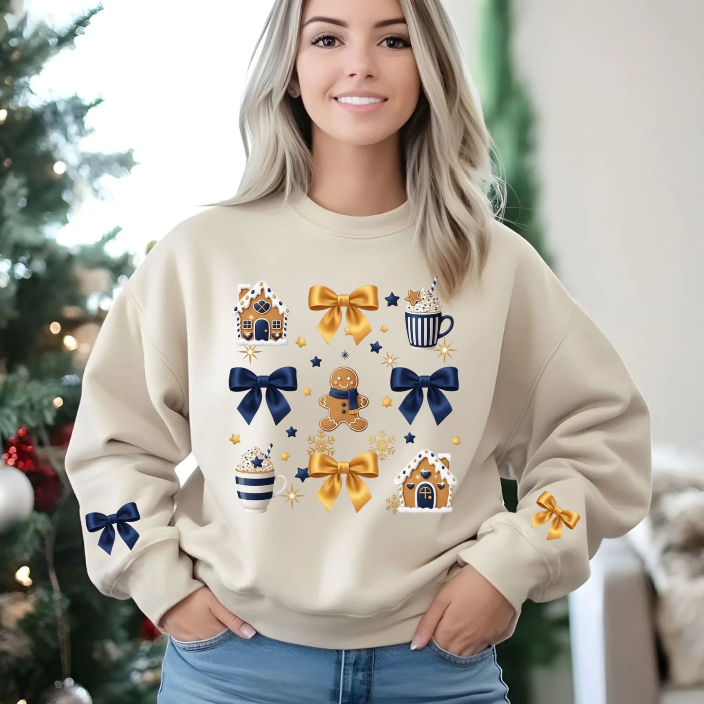 Woman wearing a beige sweatshirt with festive designs in a decorated room.