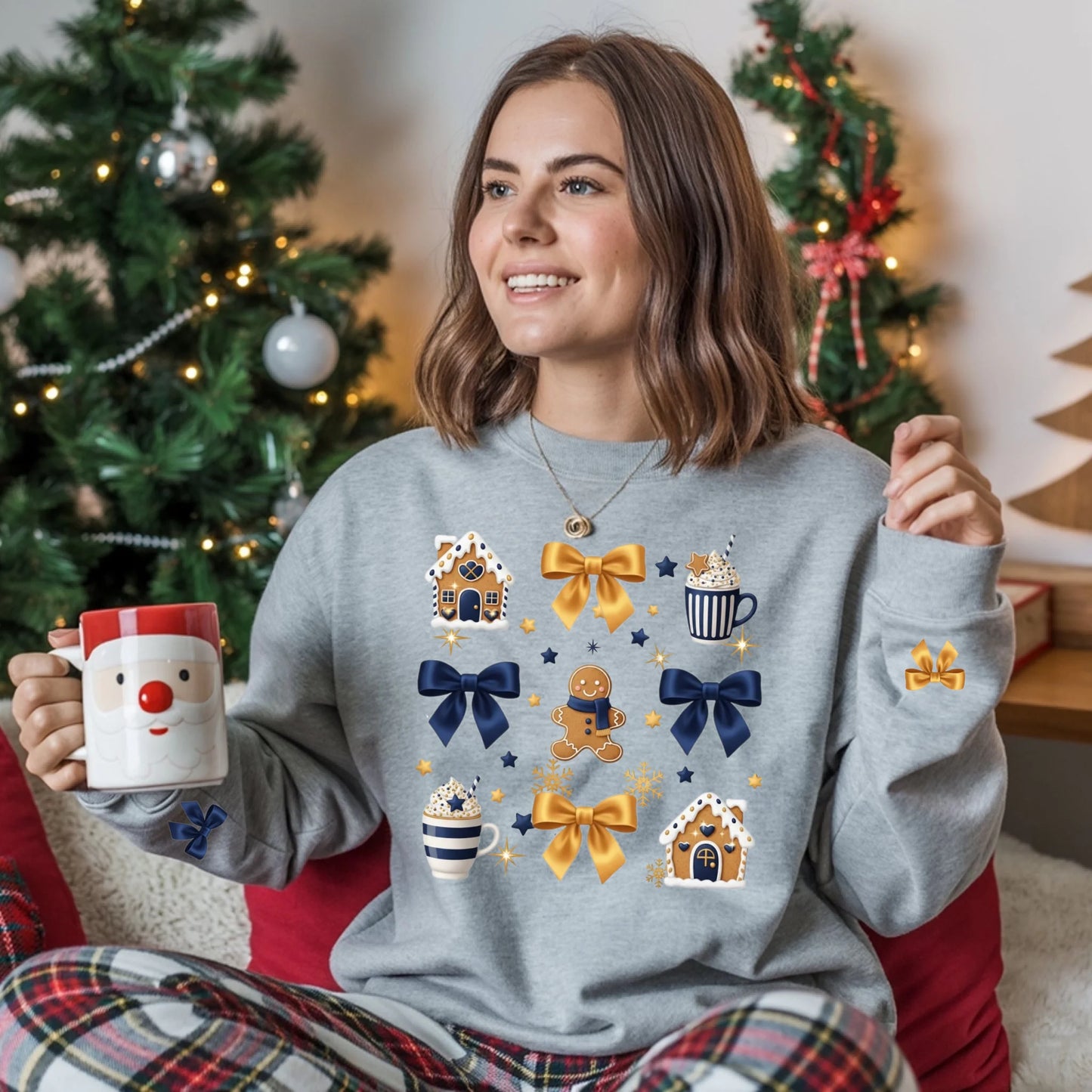 Woman wearing a festive sweater with holiday-themed designs, holding a mug, in front of a decorated Christmas tree.