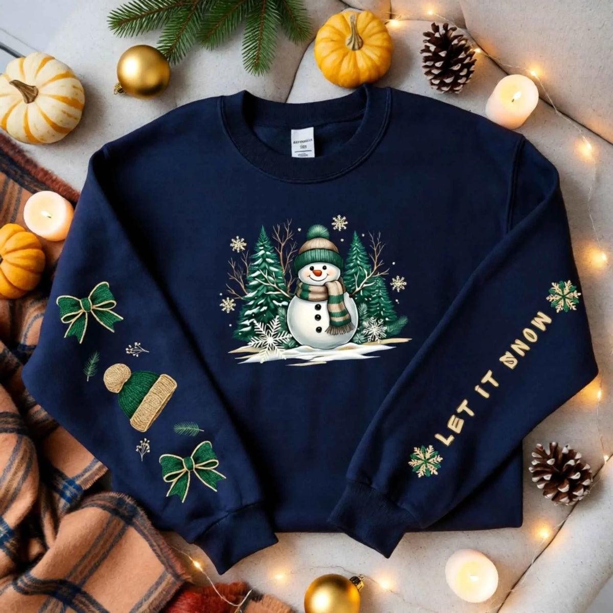 Flat lay of Snowman Winter Collection “Let It Snow” sleeve text design. Cozy Christmas Crewneck Sweatshirt