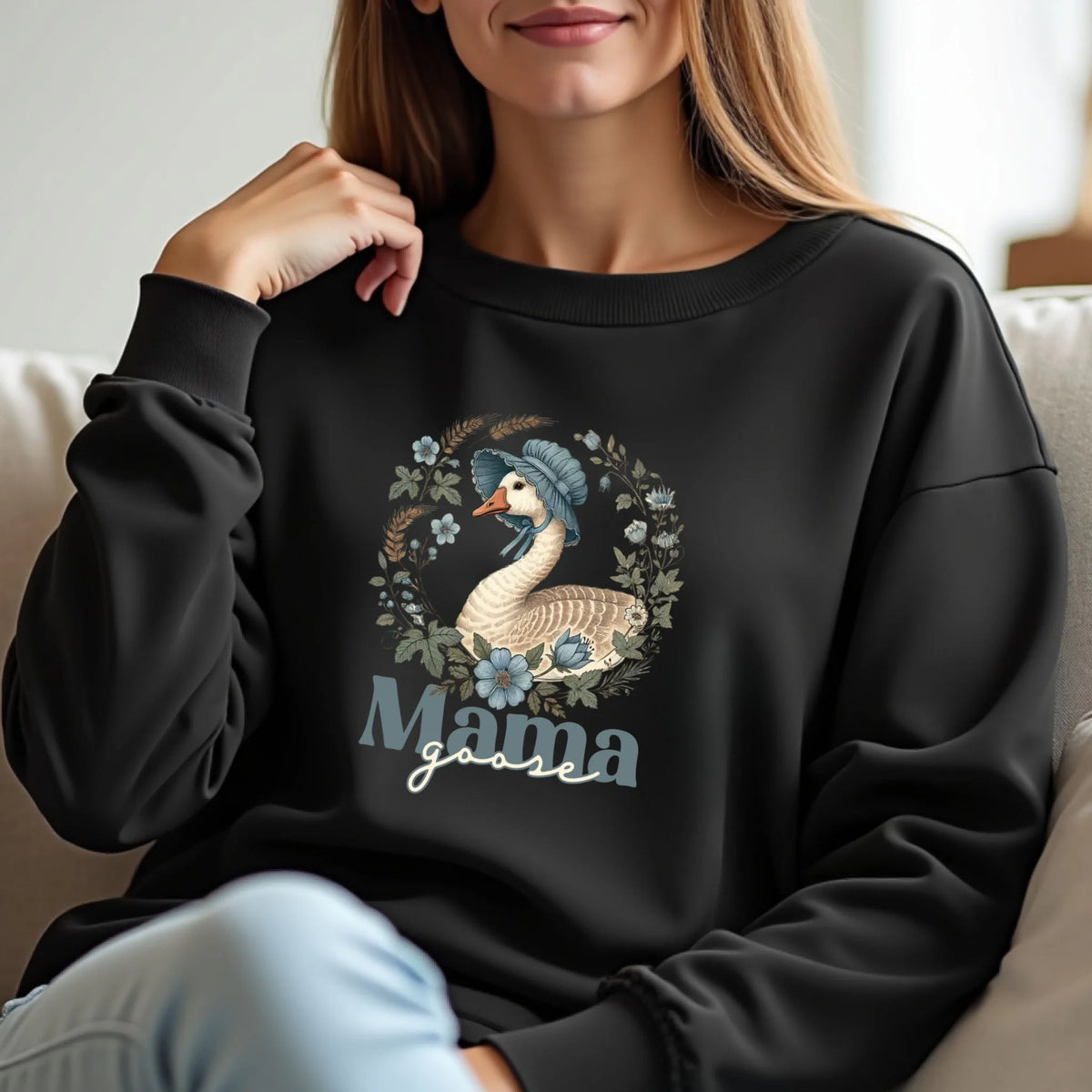 Lifestyle photo of a woman wearing a black Mama Goose floral sweatshirt featuring a vintage goose illustration and botanical accents