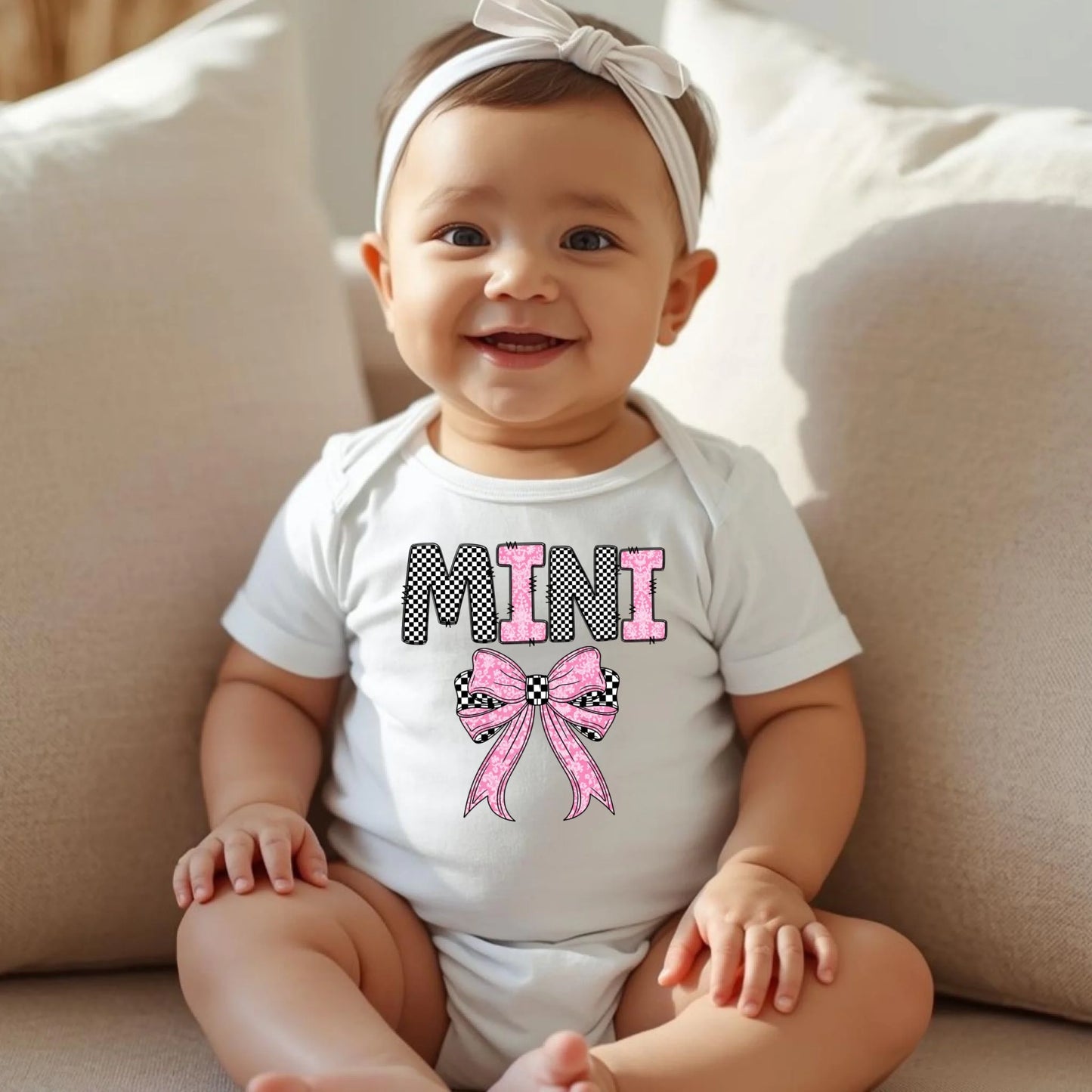 Baby wearing white Mini bow onesie, matching mommy and me outfit for newborns