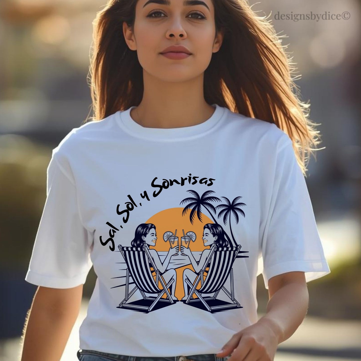 Woman wearing a white t-shirt with a graphic design of two people on lounge chairs under palm trees and a sunset, with text 'Sol, Sol y Sonrisas'.