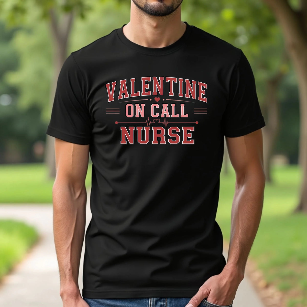 Model wearing a black Valentine On Call Nurse t-shirt outdoors with a relaxed fit and bold red collegiate text, styled for everyday wear.