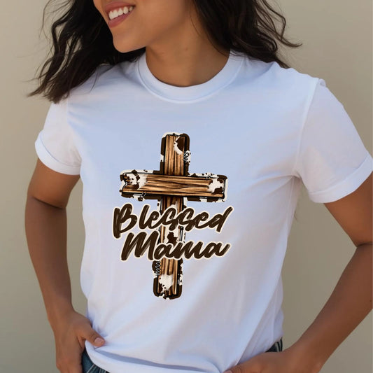 Close-up torso view of a woman wearing a white Bella Canvas Blessed Mama cross t-shirt in natural daylight.