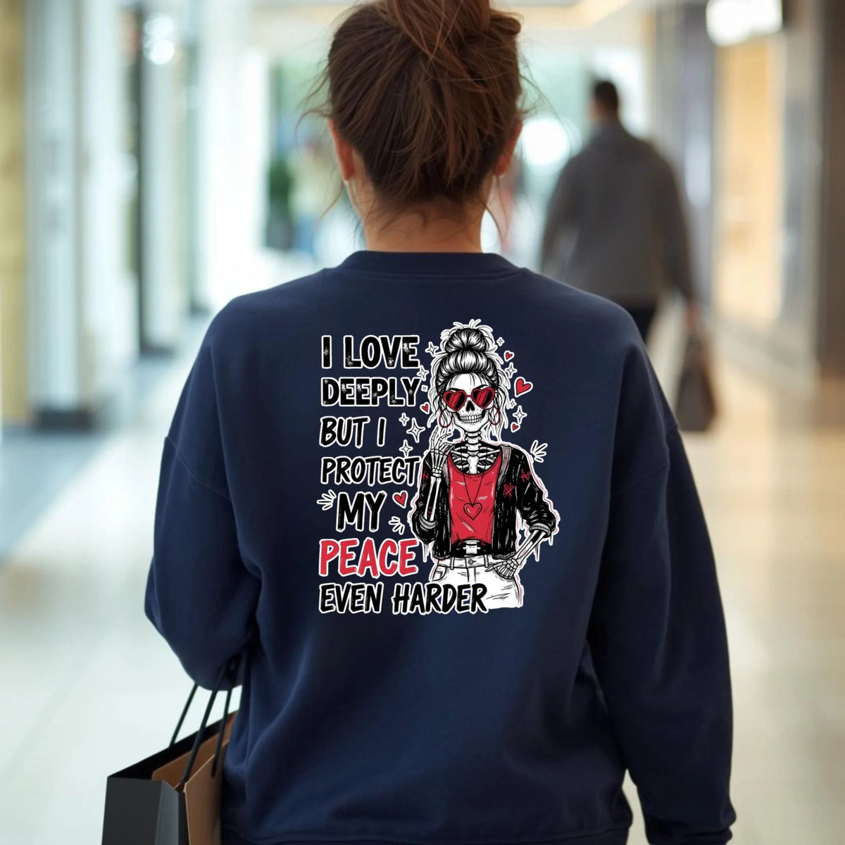 Navy Gildan crewneck showcasing skeleton self-care graphic on the back, modeled while walking through school hallway.
