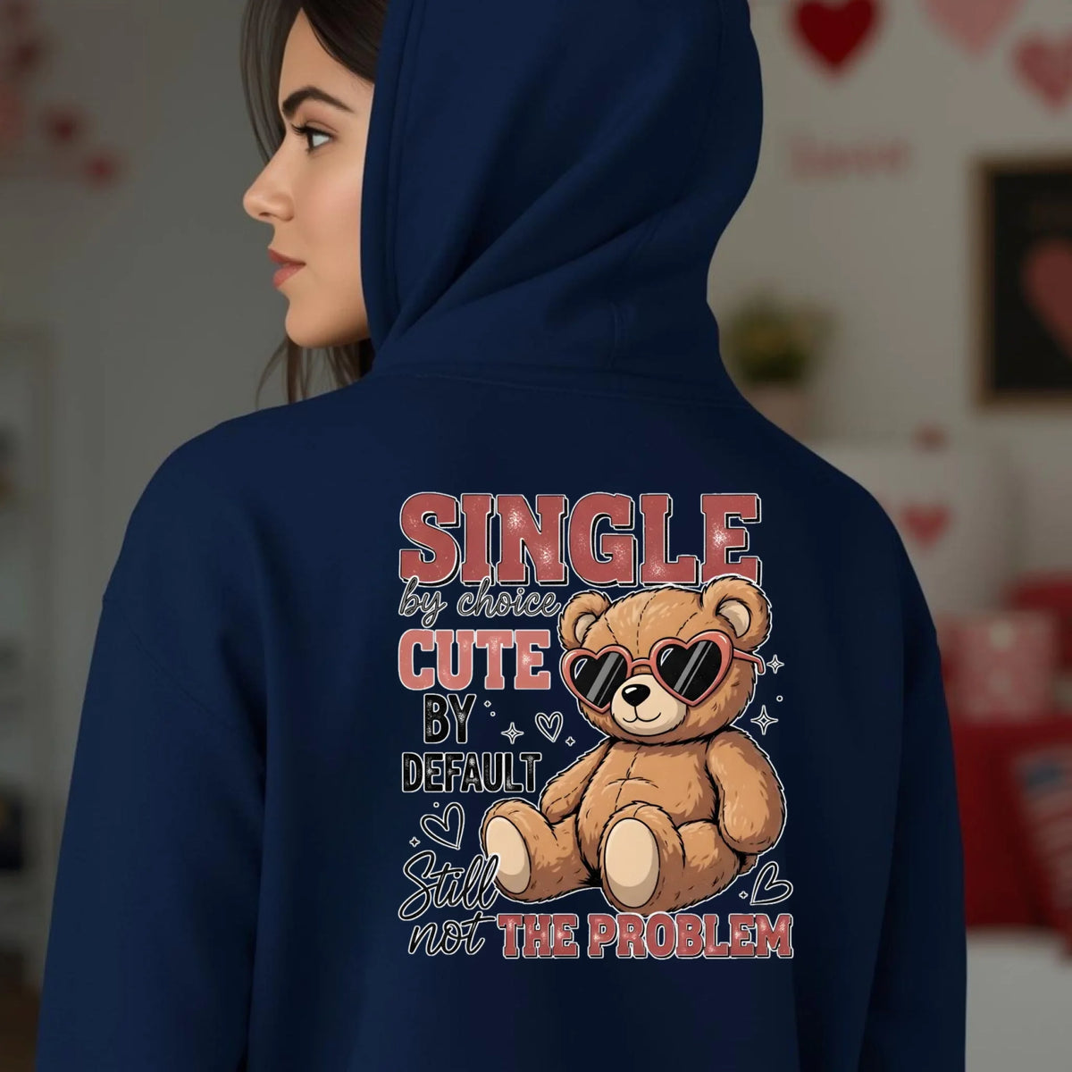 Navy blue hoodie with a teddy bear graphic and text on the back, worn by a person.
