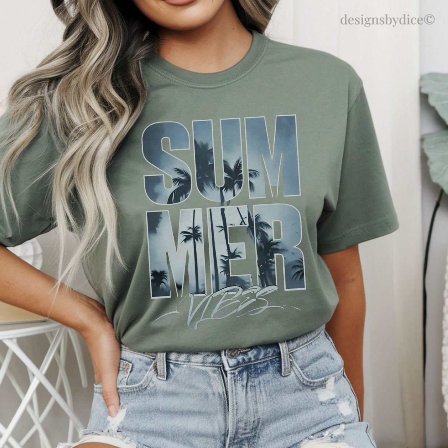Person wearing a moss green t-shirt with 'Summer Vibes' text and palm tree graphics.