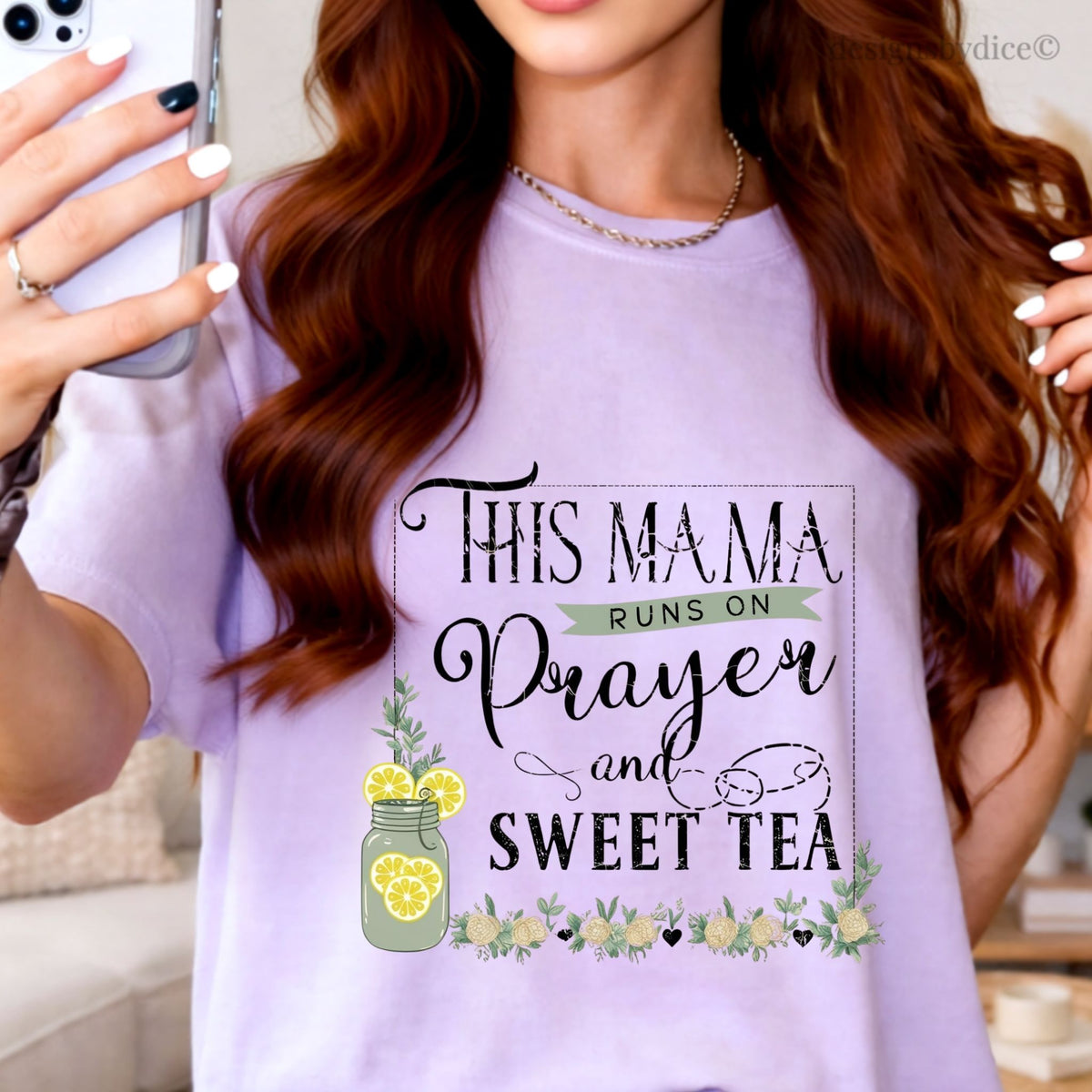 Woman wearing a orchid t-shirt with text 'This mama runs on prayer and sweet tea' and lemon graphics.