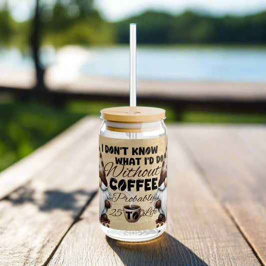 Glass tumbler with wooden lid and straw, featuring a coffee-themed design and text.