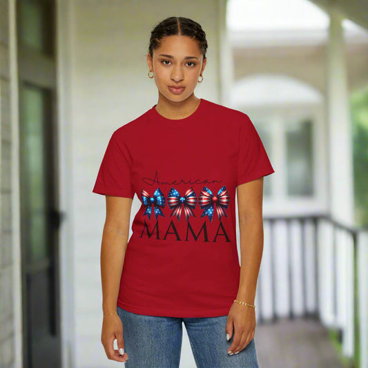 Person wearing a red t-shirt with 'MAMA' and decorative elements on a white background