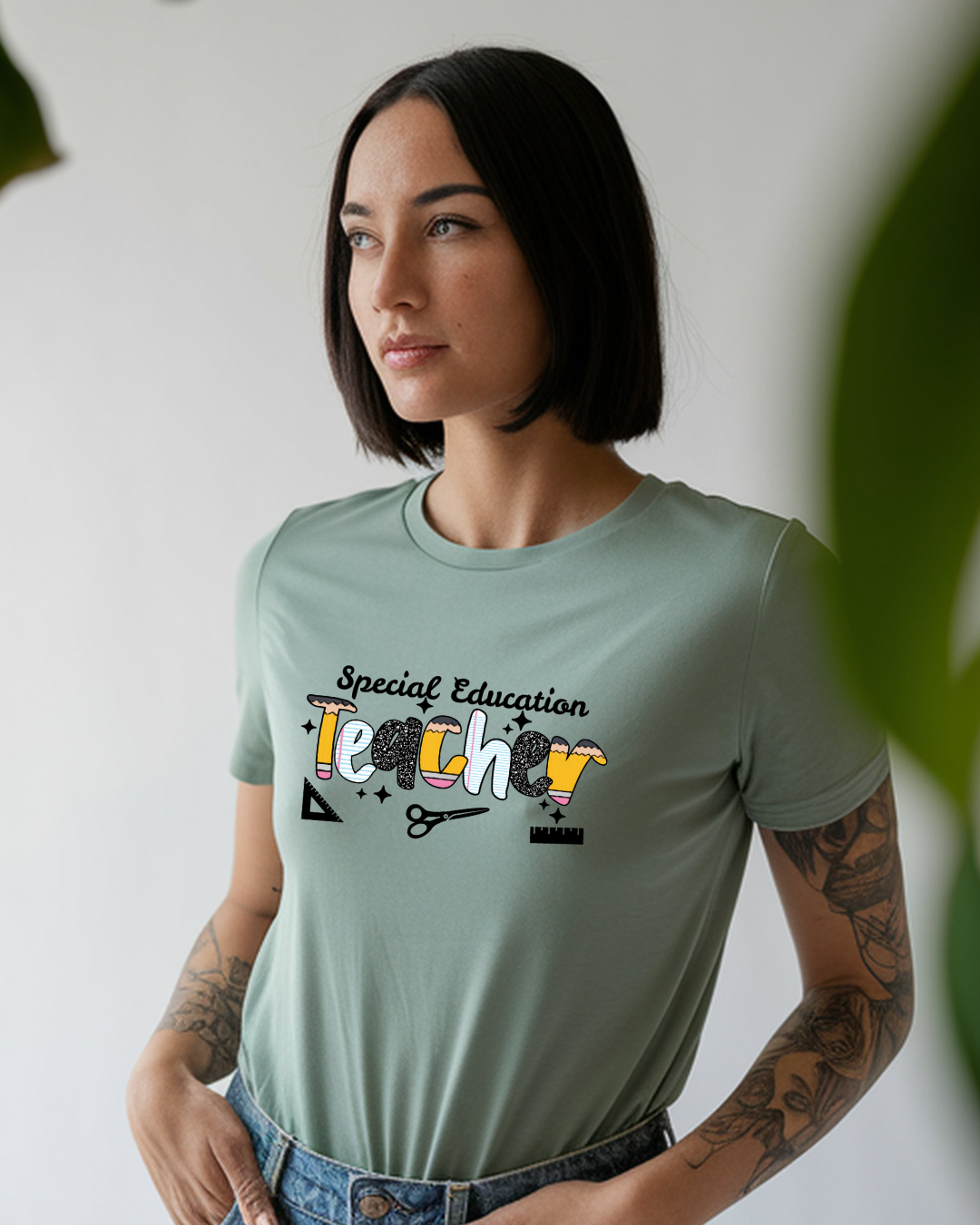 Woman wearing a light green t-shirt with 'Special Education Teacher' text and graphics.