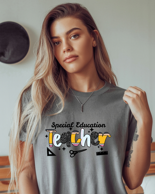 Woman wearing a gray t-shirt with 'Special Education Teacher' text and graphics.
