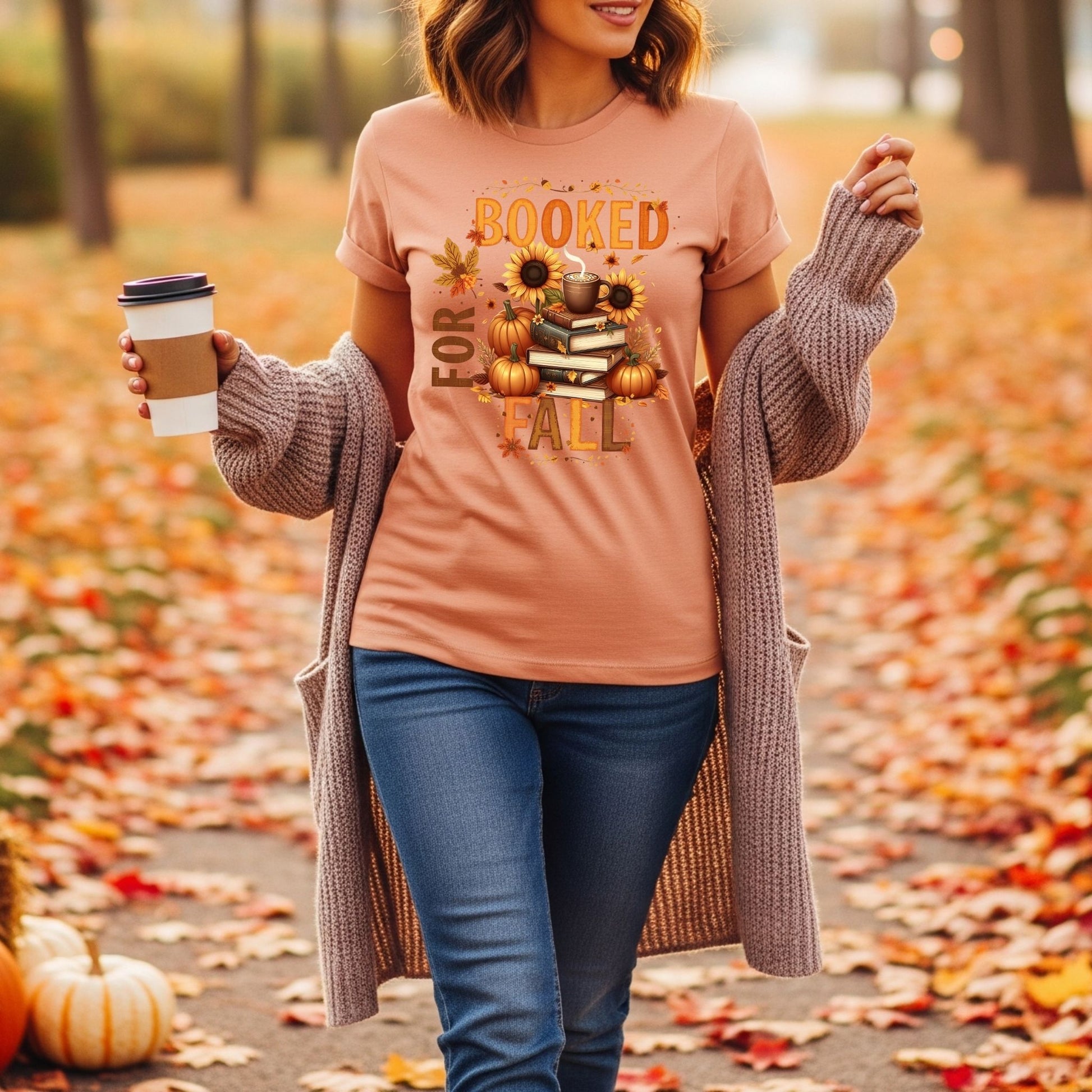 Woman wearing a 'Booked for Fall' shirt in an autumn setting