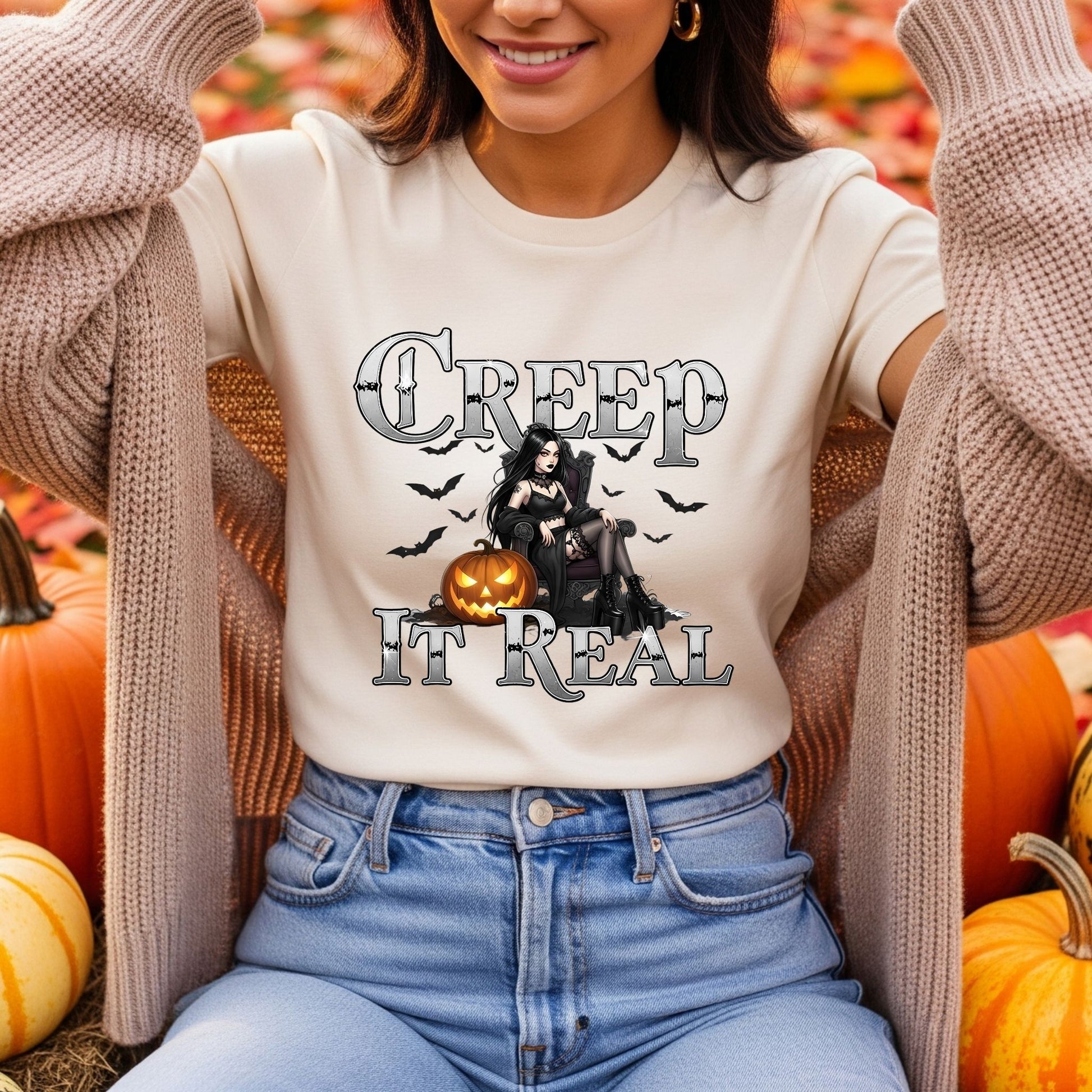 Person wearing a Halloween-themed t-shirt with pumpkins and text in an outdoor setting.