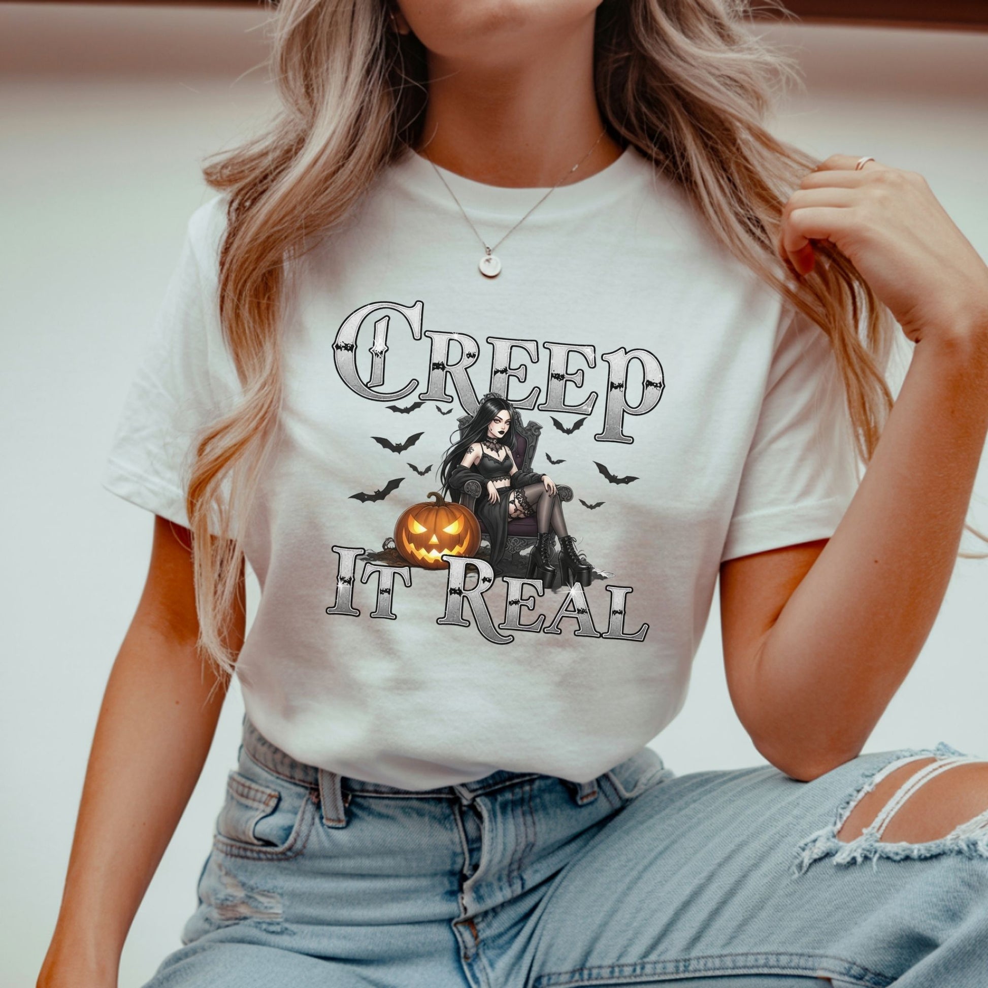 Person wearing a white t-shirt with Halloween-themed design and text.