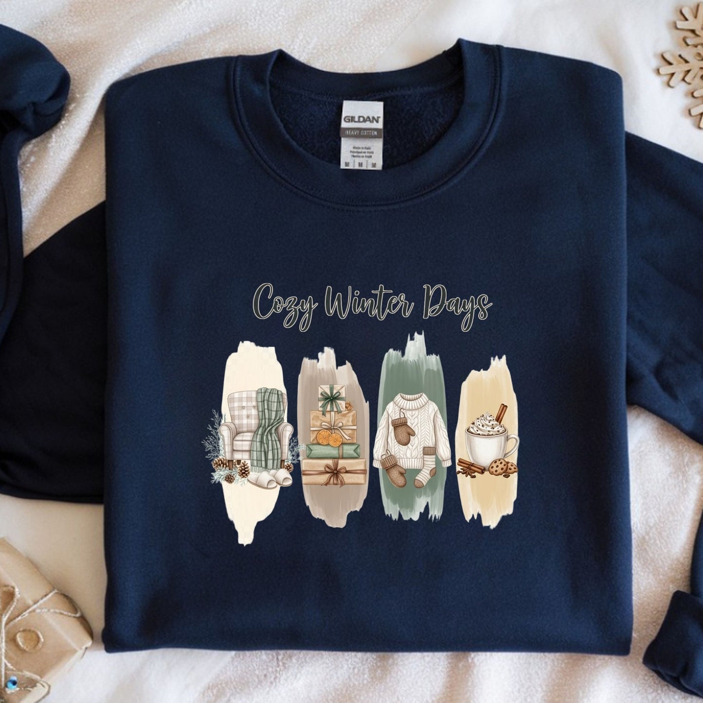 Navy blue sweatshirt with 'Cozy Winter Days' text and winter-themed illustrations on a textured surface.
