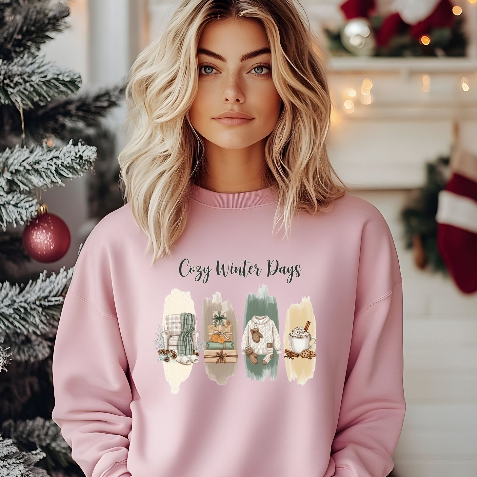 Person wearing a pink sweatshirt with 'Cozy Winter Days' text and winter-themed illustrations in a festive setting.