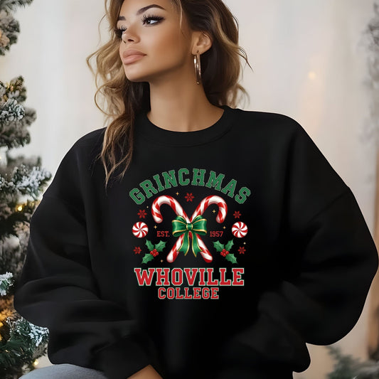 Person wearing a black sweatshirt with 'Grinchmas Whoville College' design in a festive setting.