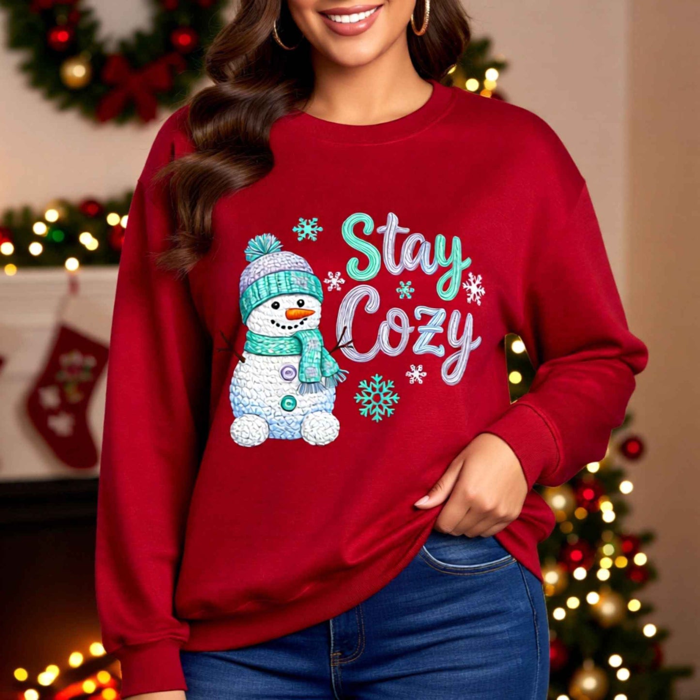 Woman wearing faux crochet knit Christmas crewneck sweatshirt with “Stay Cozy” snowman winter design