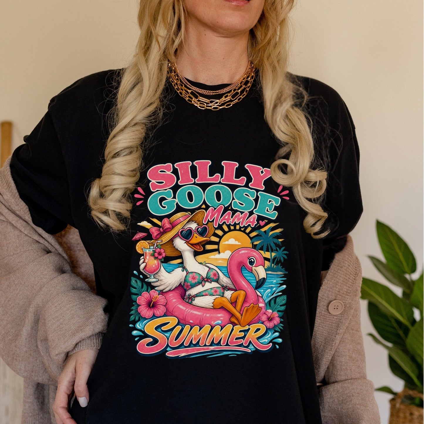Woman wearing a black comfort colors tshirt with a silly goose mama summer graphic design