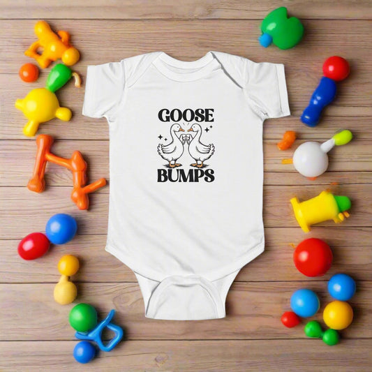 White baby onesie with 'GOOSE BUMPS' text and graphic on a white background