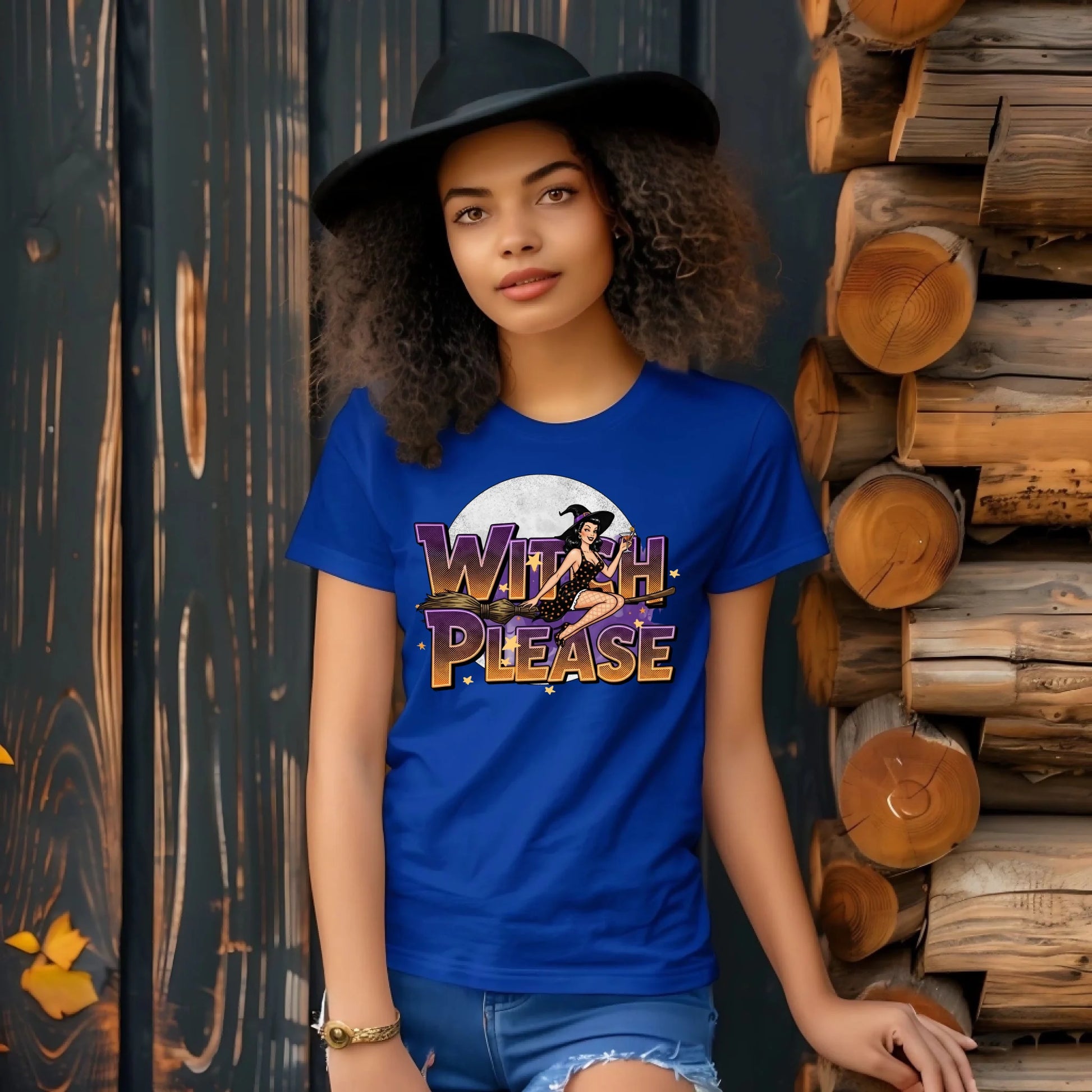 Woman wearing a blue t-shirt with 'Witch Please' design against a wooden background