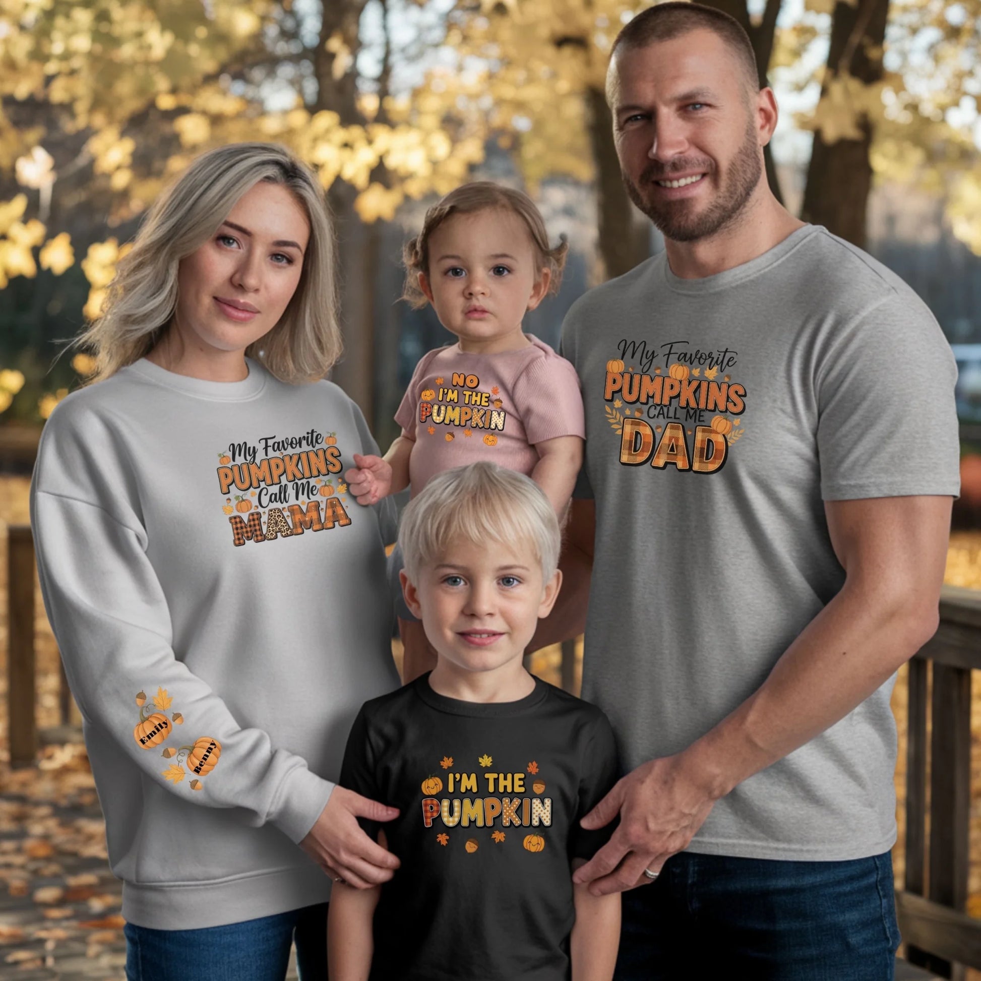 Family of four wearing matching Halloween-themed shirts outdoors with trees in the background.