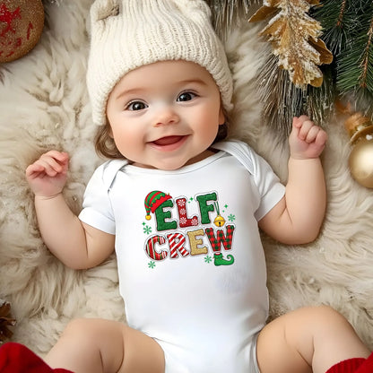 Baby wearing a 'Elf Crew' Christmas-themed onesie surrounded by holiday decorations.