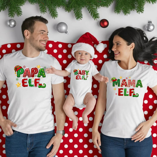 Family of three wearing matching 'Elf' themed shirts on a polka dot background.