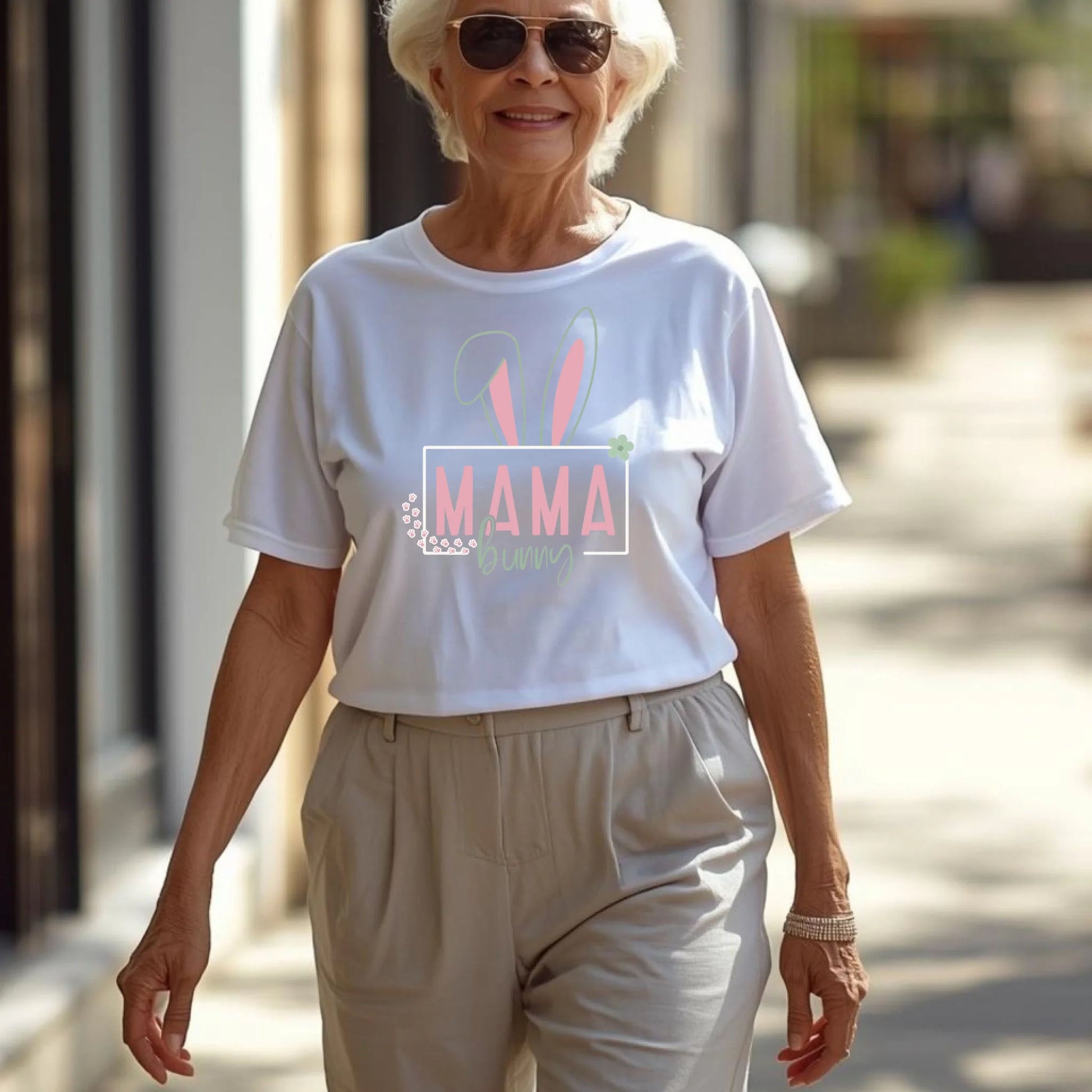 Woman wearing a white Easter bunny mama t-shirt walking outdoors in a relaxed spring environment.