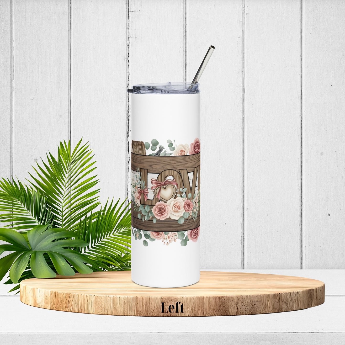 Left-side tumbler angle showing the start of the LOVE letters with twine, florals, and soft pink roses on distressed wood.