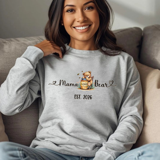 Woman wearing a grey mama bear crewneck sweatshirt featuring a honey bear illustration and custom EST year.