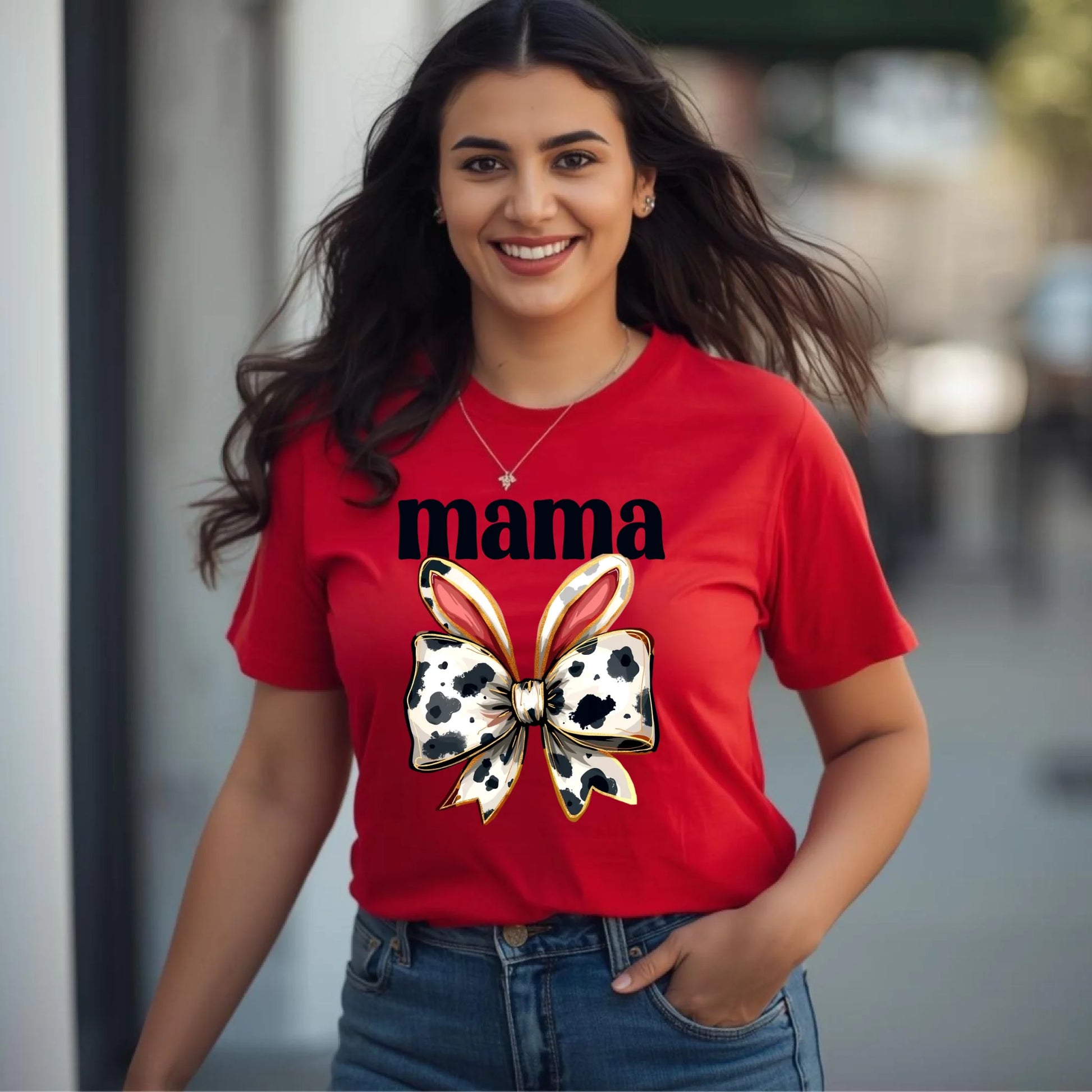 Woman wearing a red mama cow bunny bow t-shirt, western-inspired Mother’s Day shirt styled casually outdoors.