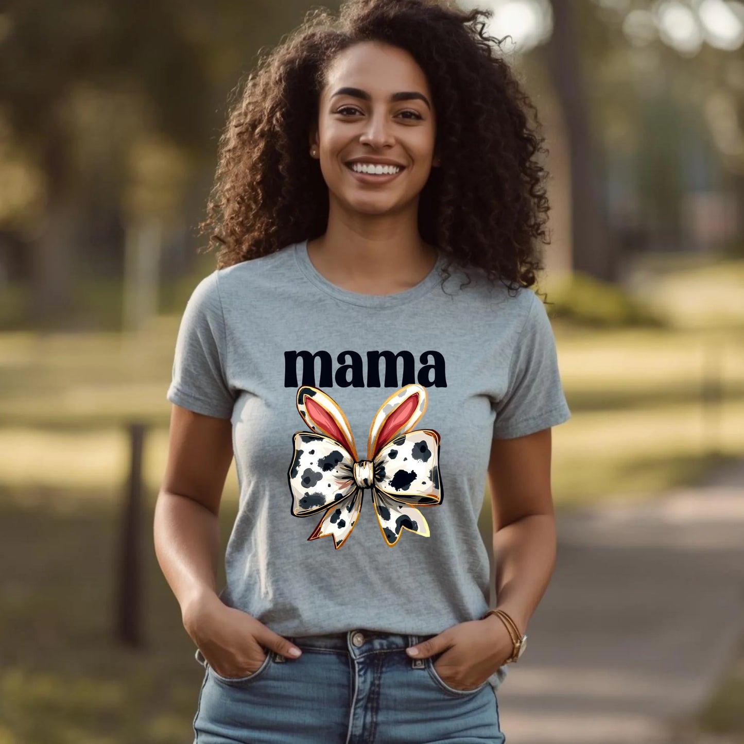 Woman wearing a heather gray mama cow bunny bow t-shirt, relaxed fit, styled with jeans for a casual Mother’s Day outfit.