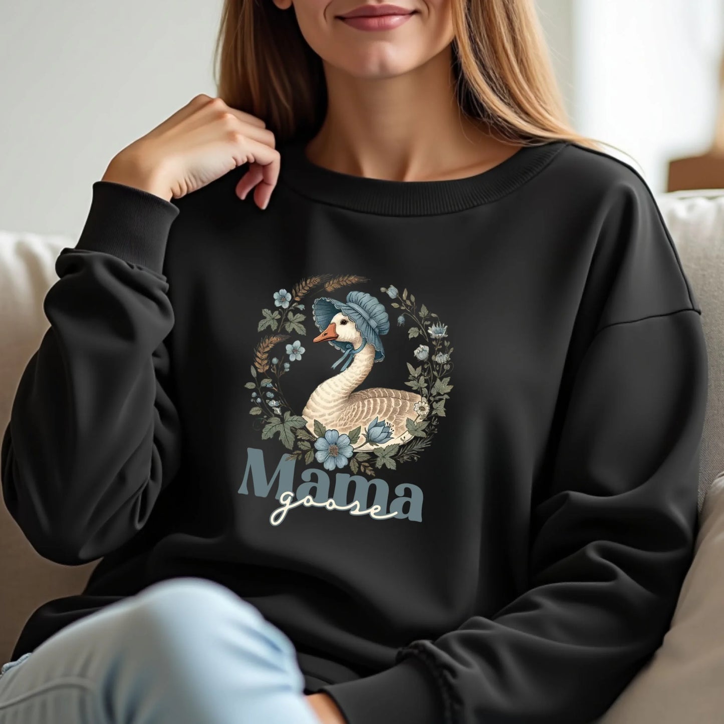 Lifestyle photo of a woman wearing a black Mama Goose floral sweatshirt featuring a vintage goose illustration and botanical accents