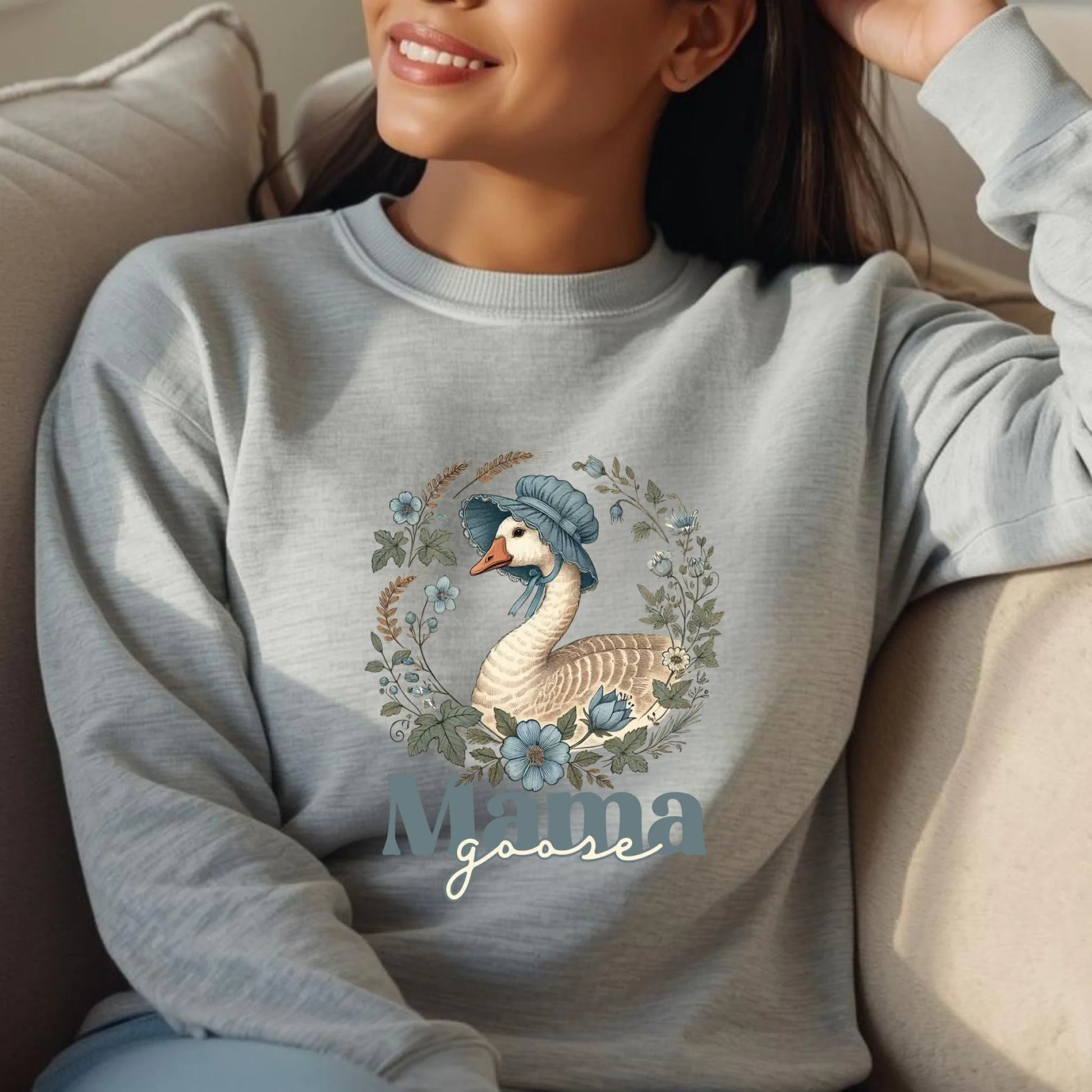 Relaxed lifestyle shot of a woman wearing a heather gray Mama Goose floral sweatshirt, styled comfortably for everyday wear.