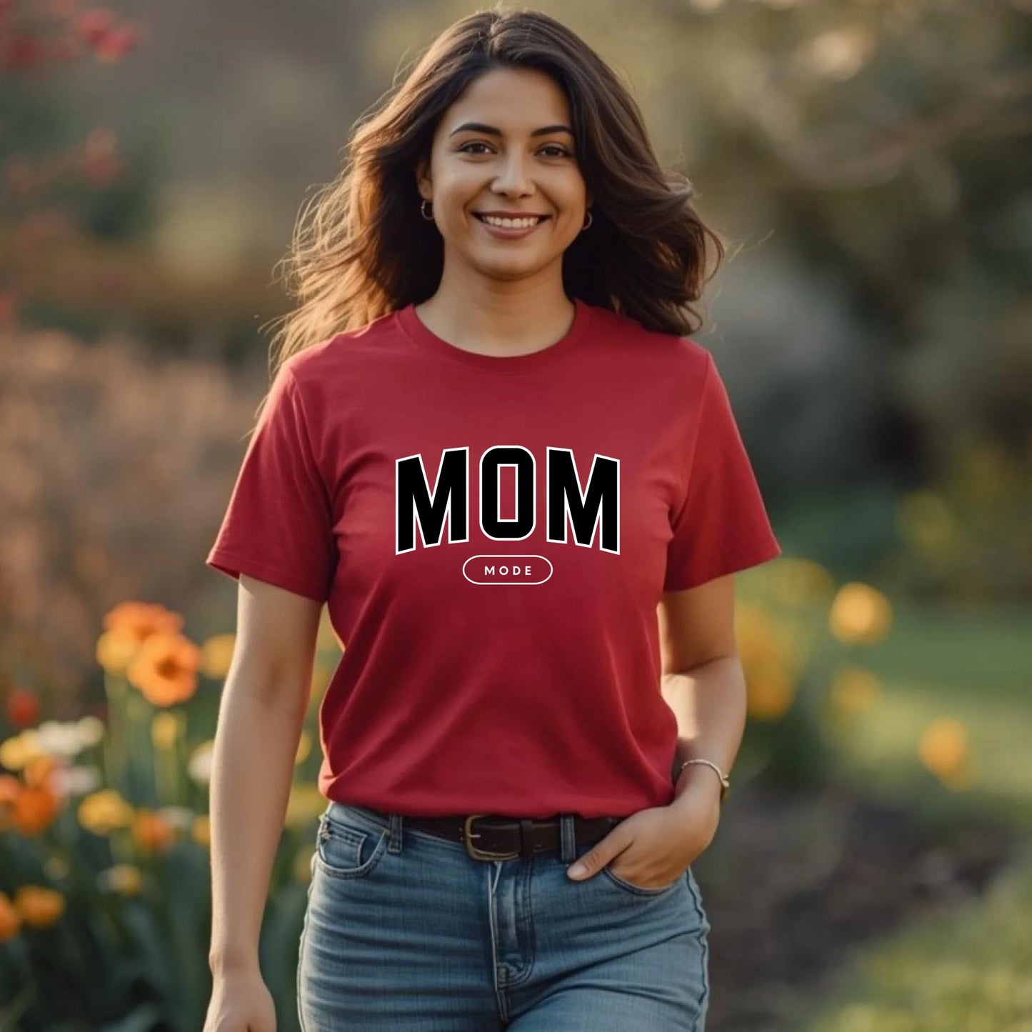 Woman wearing a cardinal red 'MOM' t-shirt in a garden setting