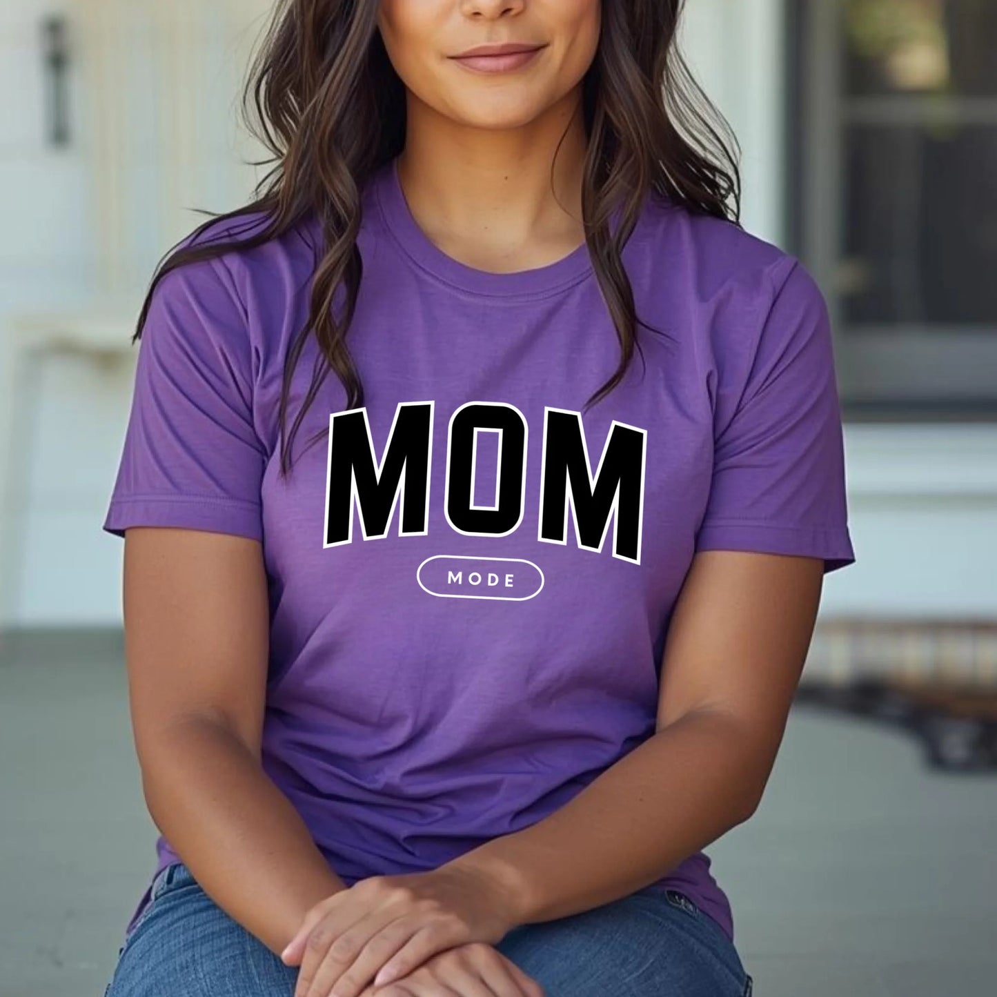 Person wearing a purple t-shirt with 'MOM MODE' text.
