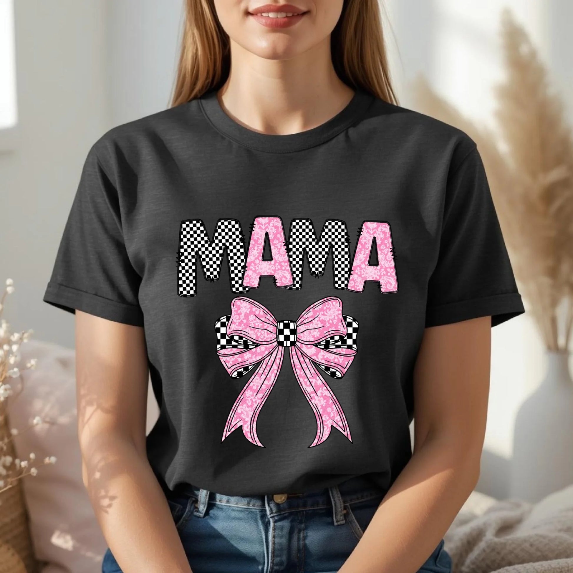 Woman wearing black Mama bow graphic shirt, bold and playful Mother’s Day outfit idea
