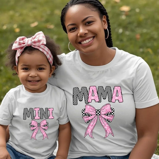 Mother and toddler wearing matching Mama and Mini checkered bow shirts outdoors, stylish mommy and me outfits for Mother’s Day and family photos