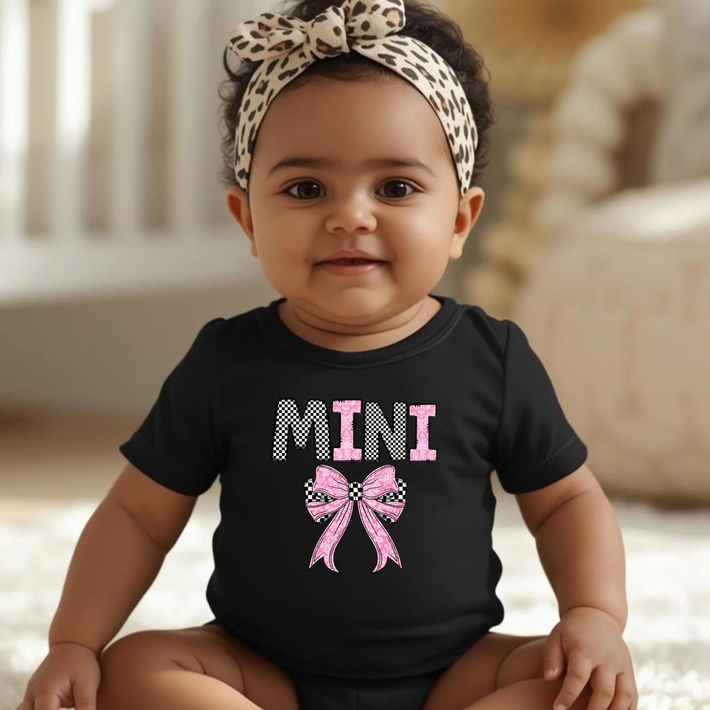 Baby wearing black Mini bow onesie, mommy and me matching baby outfit