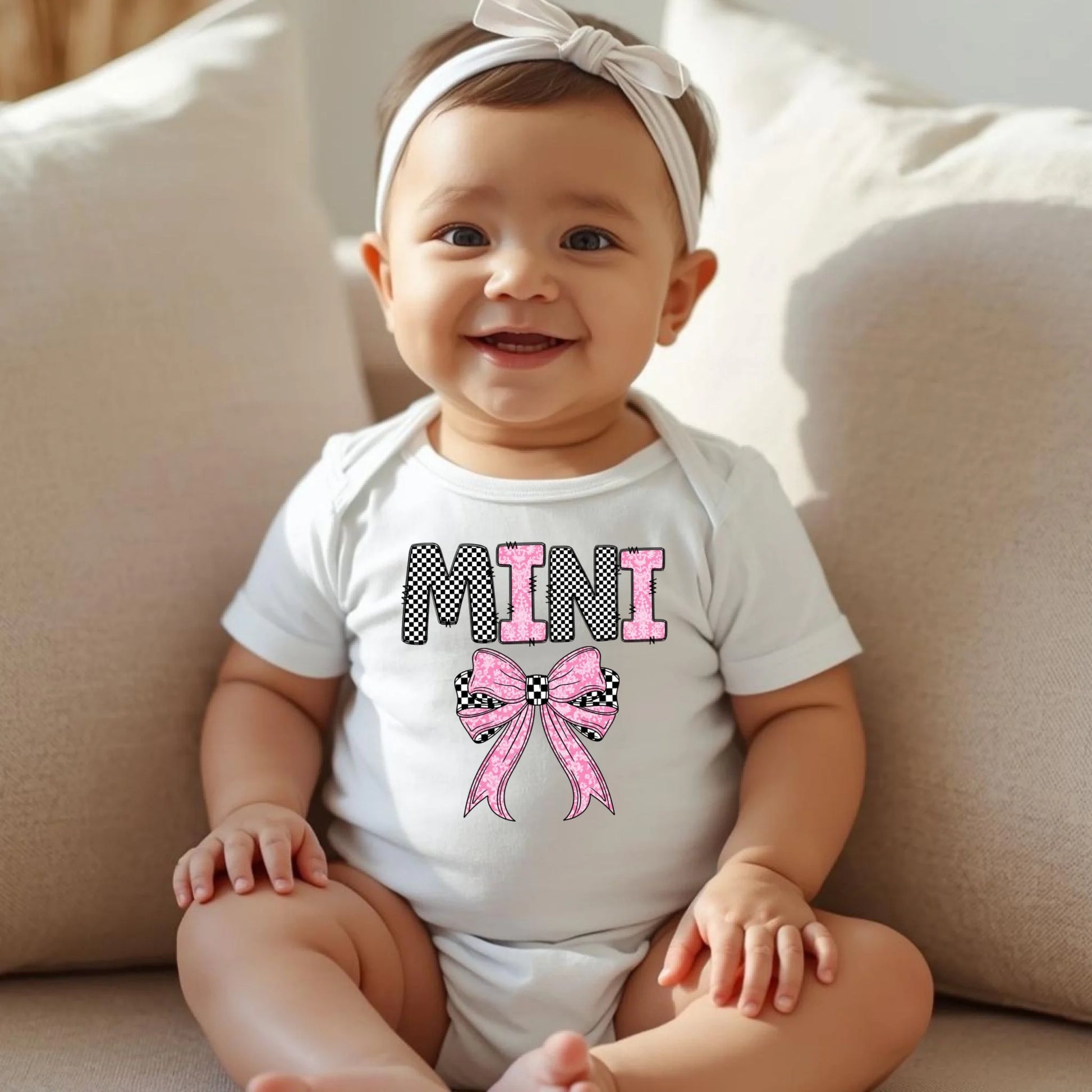 Baby wearing white Mini bow onesie, matching mommy and me outfit for newborns