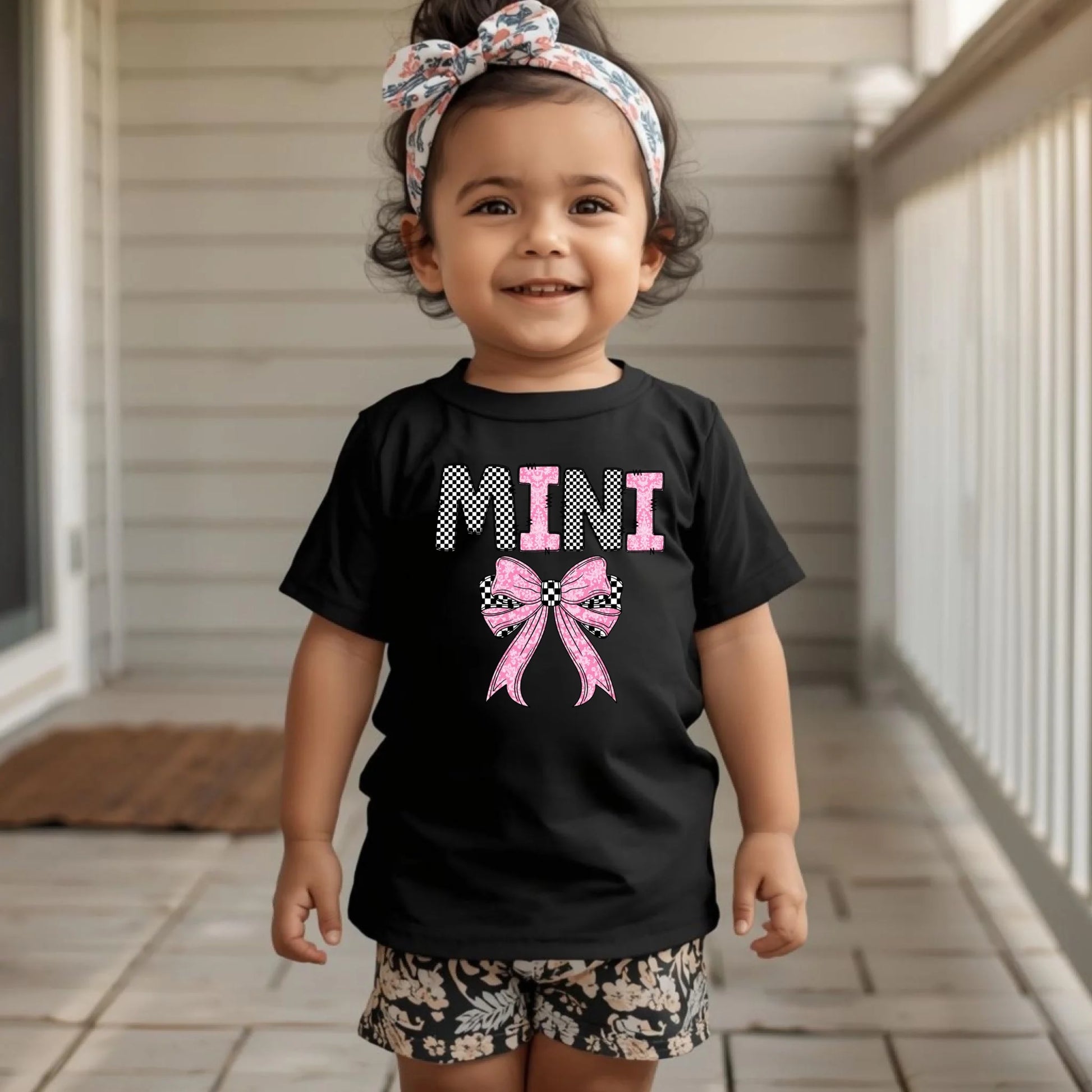 Toddler wearing black Mini bow shirt, cute mommy and me matching outfit for Mother’s Day
